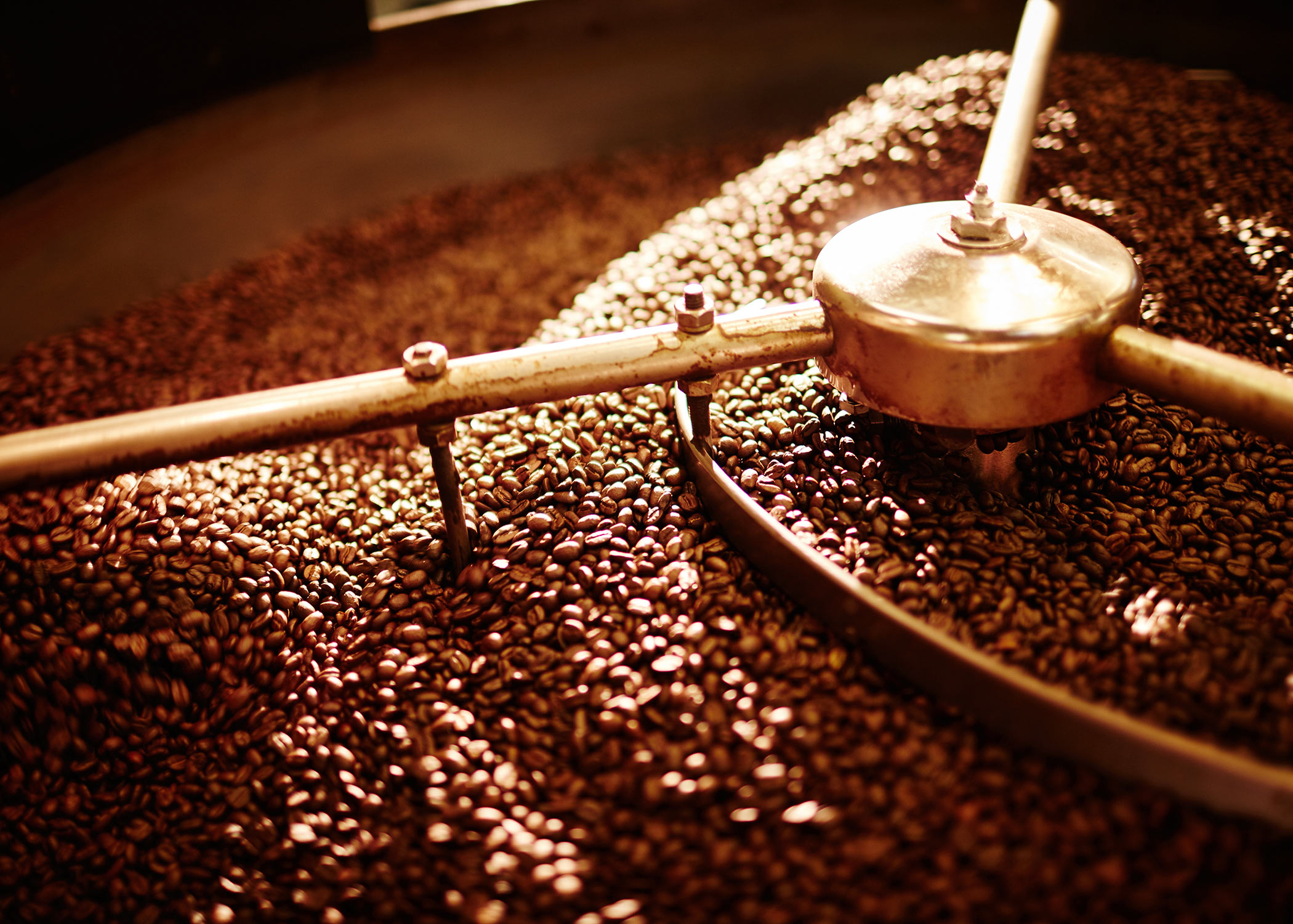Freshly roasted coffee beans are turned in the cooling tray at Northwest Coffee in St. Louis, Missouri